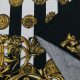 Трикотаж хлопковый с купонным лого-принтом, золото на черно-белом (014185)